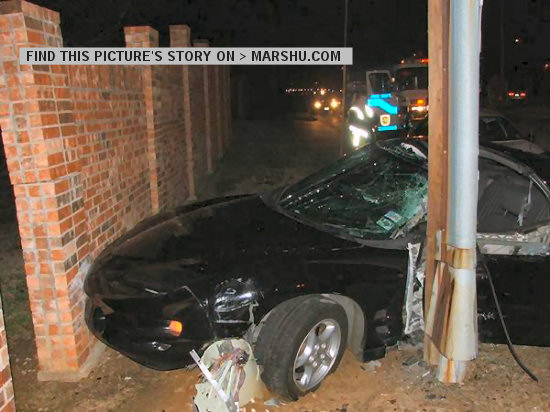 firebird car crash: outside car front with telephone pole and brick wall. You can see emergency workers in background